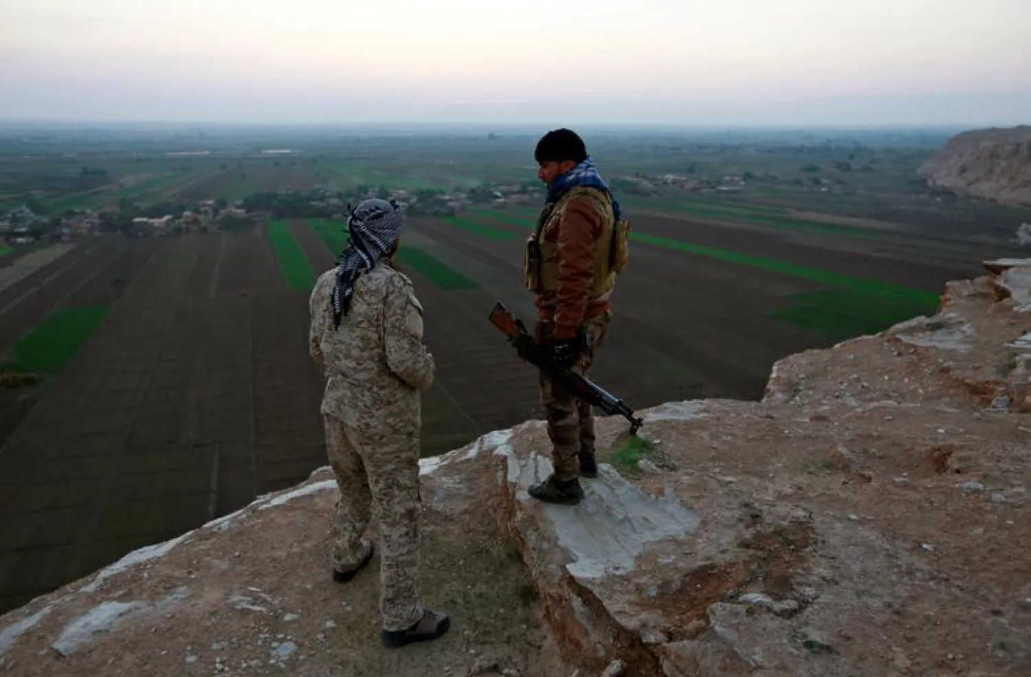 FILE PHOTO: Popular Mobilization Forces (PMF) fighters stand on a hill at the Iraqi-Syrian border near al-Qaim, Iraq. November 25, 2018. REUTERS/Alaa al-Marjani/File Photo
