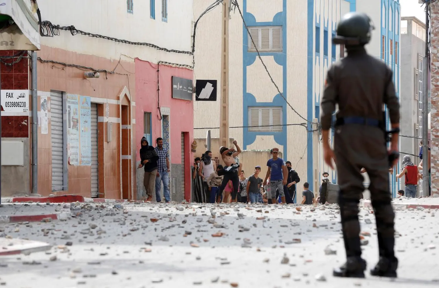  Protesters throw stones towards riot police as they demonstrate against alleged corruption in the provincial town of Imzouren, Morocco, June 2, 2017. Reuters/Youssef Boudlal