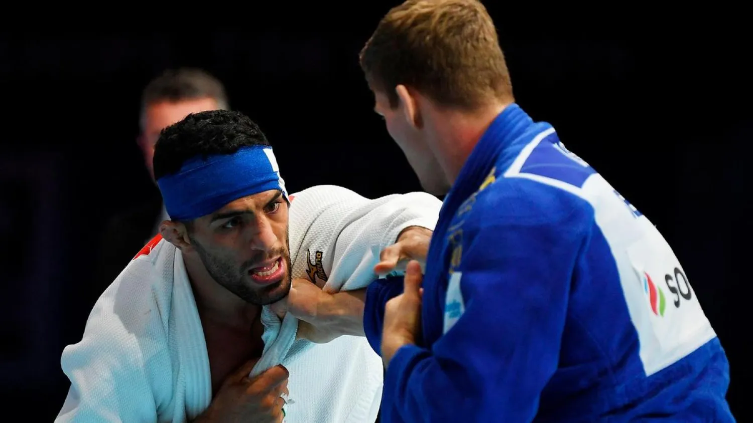 Iran's Saeid Mollaei, left, fights Belgium's Matthias Casse during the semi-final of the men's under 81kg category during the 2019 Judo World Championships at the Nippon Budokan, Tokyo, Japan. (AFP)