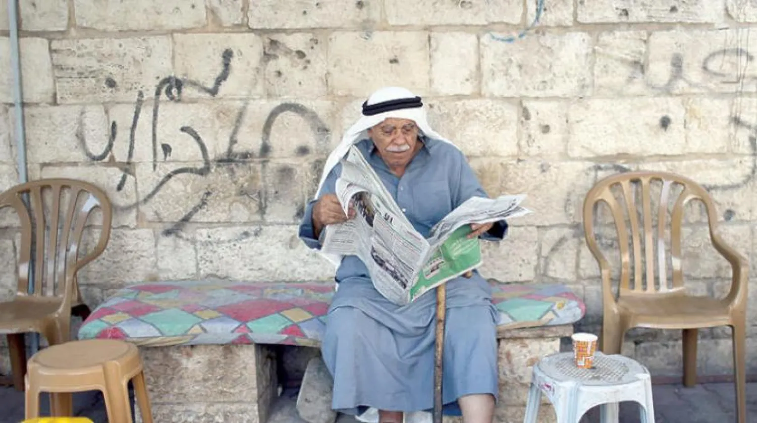 A Palestinian from southern Gaza reads Israeli election news  (Reuters)
