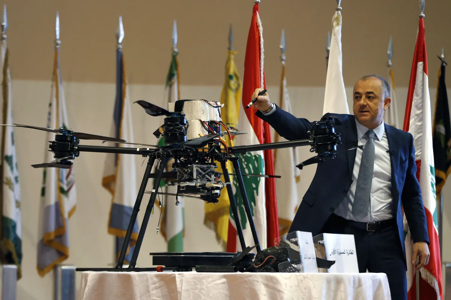Lebanese Defense Minister Elias Bou Saab points to parts of an Israeli drone that crashed in southern Beirut last month during a press conference at the Lebanese Defense Ministry, in Yarzeh near Beirut, Lebanon, Thursday, Sept. 19, 2019. (AP Photo/Bilal Hussein)