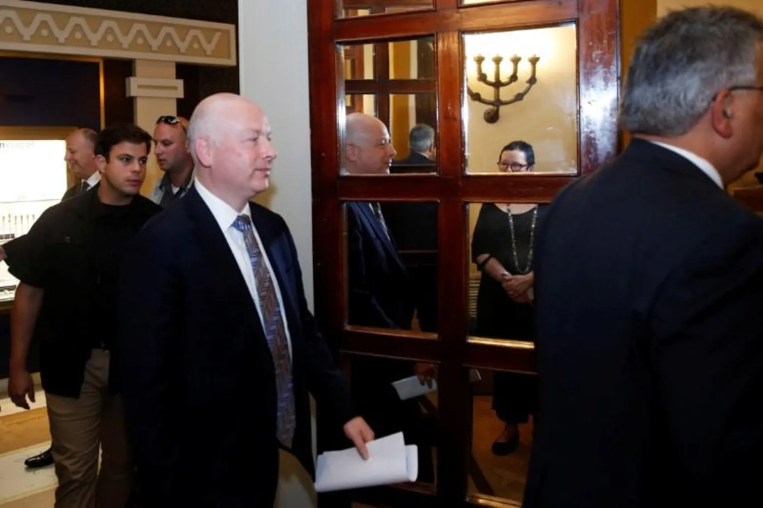 Jason Greenblatt (C), US President Donald Trump's Middle East envoy, is reflected in a mirror as he enters a room to hold a news conference in Jerusalem, July 13, 2017. REUTERS/Ronen Zvulun