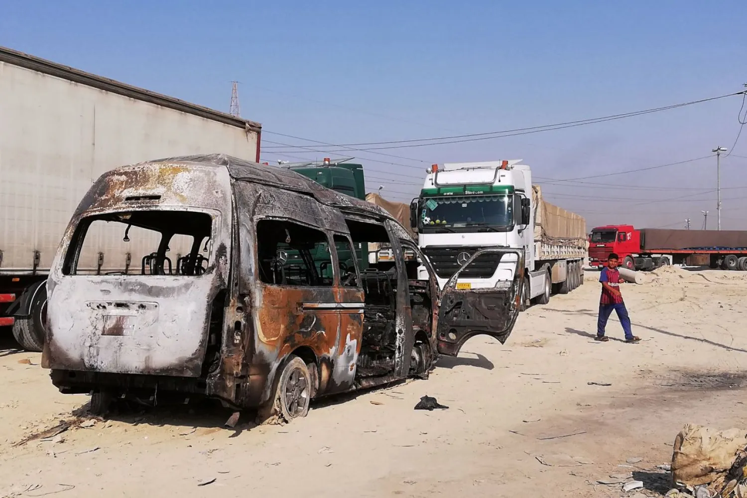 A destroyed minibus sits near an Iraqi army checkpoint south of Karbala, Iraq, Saturday, Sept. 21, 2019. (AP Photo/Hadi Mizban)