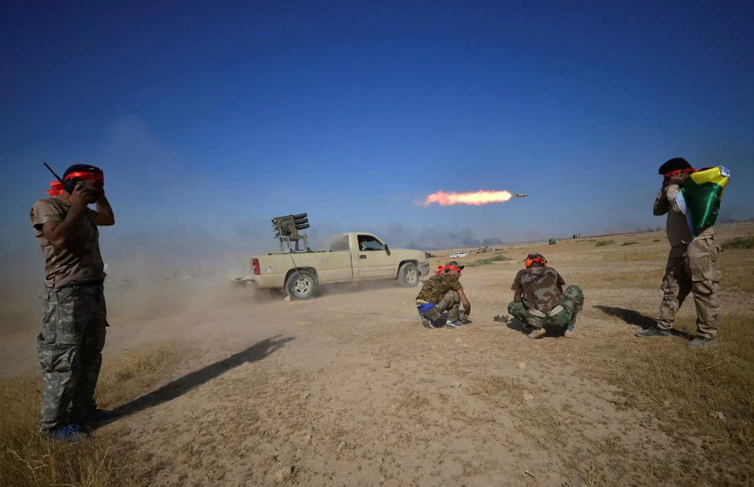 Popular Mobilization Forces (PMF) launch a rocket towards ISIS militants on the outskirts of Tal Afar, Iraq, August 22, 2017. REUTERS/Stringer