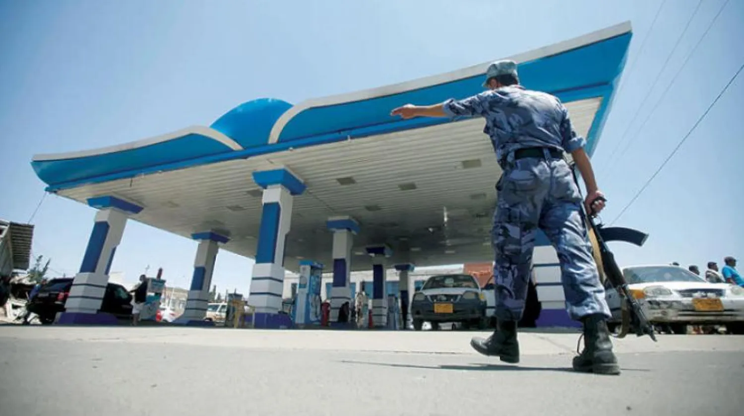 Armed man infront of a gas station in Sanaa (Reuters)