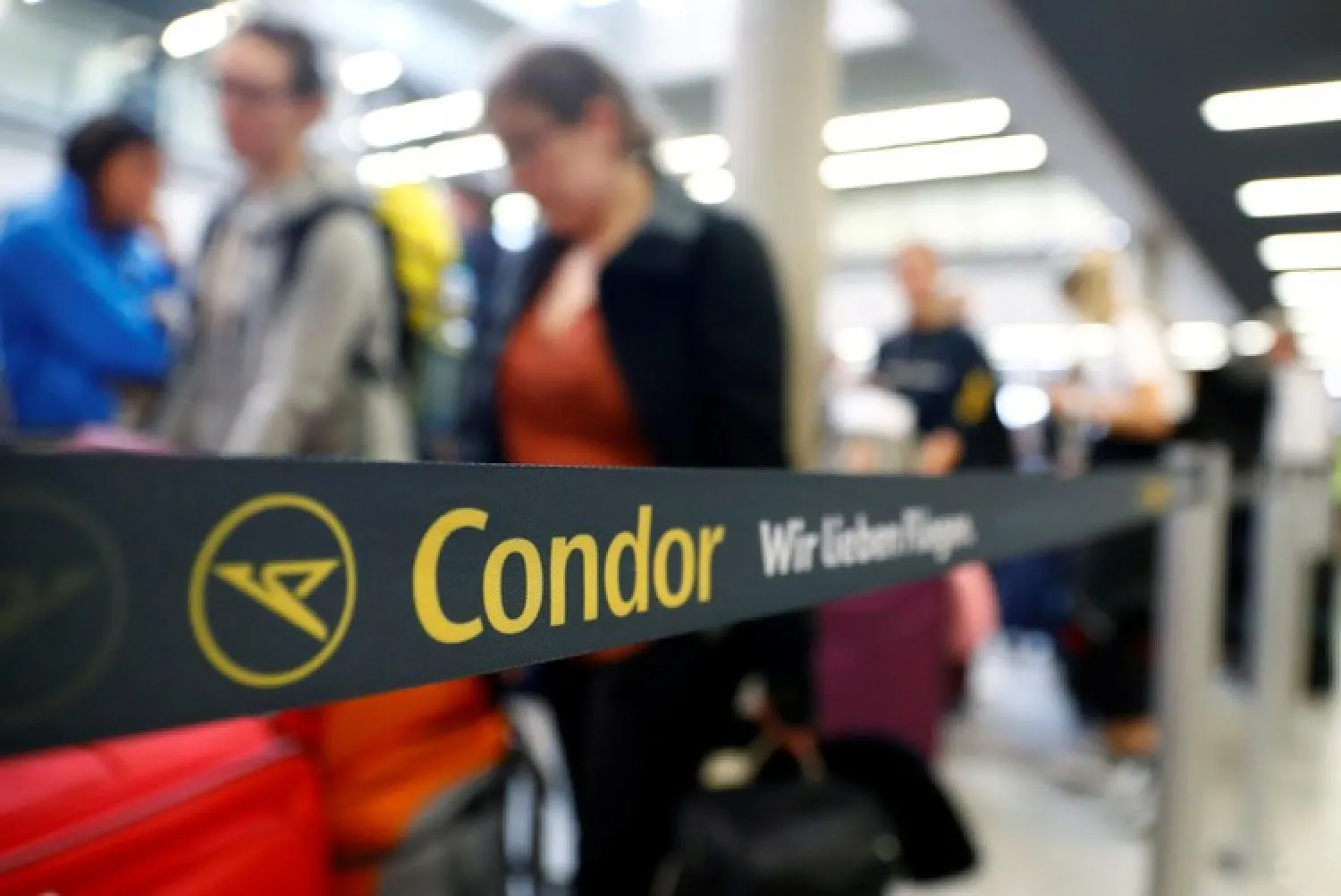 Travellers queue up in a Condor check-in service at the Frankfurt Airport, Germany September 23, 2019. REUTERS/Kai Pfaffenbach
