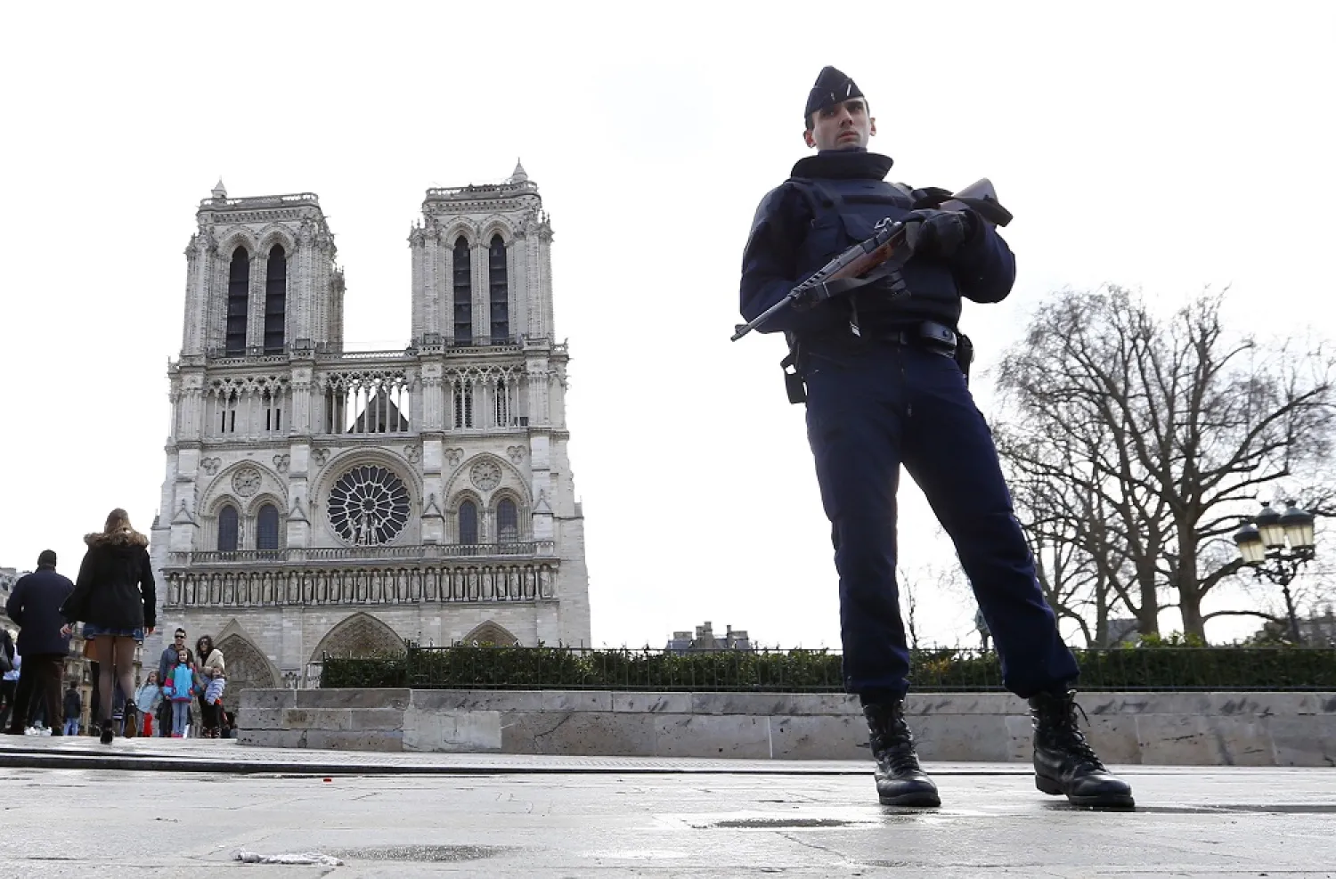 In this March 27, 2016 file photo, a French police officer stands guards as worshipers arrive for the Easter mass at Notre Dame Cathedral, in Paris. (AP)