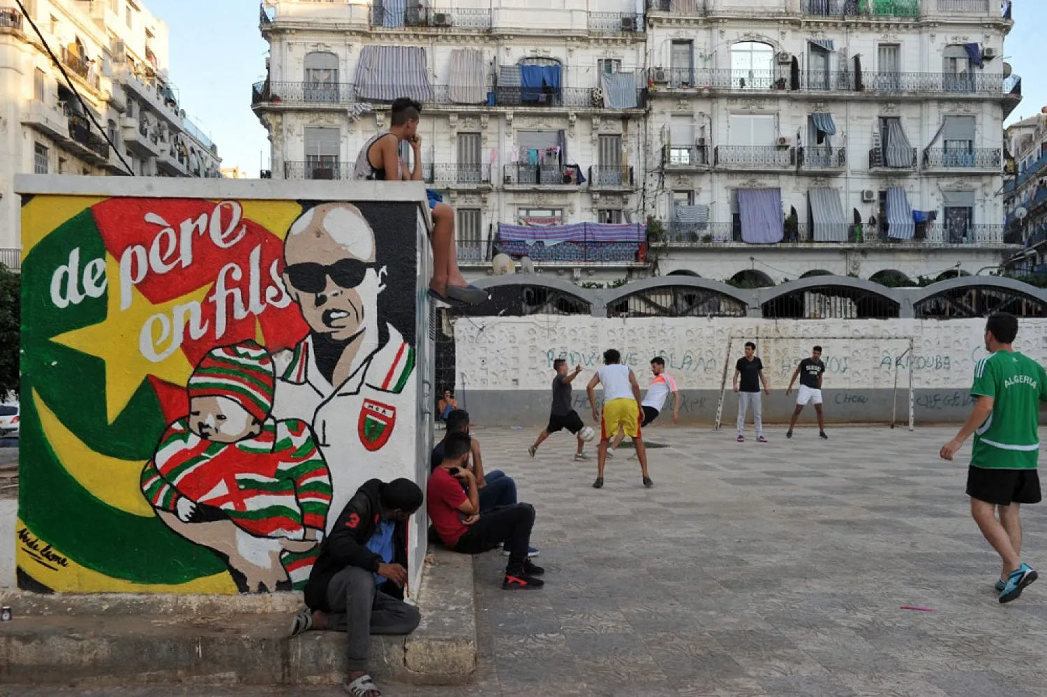 Algerians play football in the street in the Bab el-Oued neighborhood in Algiers on October 11, 2016. (Getty Images)
