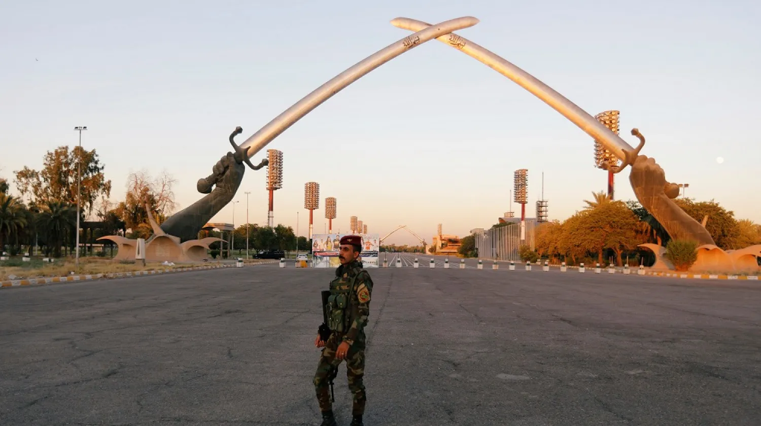 An Iraqi security officer walks near the Arch of Victory memorial in the Green Zone of Baghdad, Iraq July 15, 2019. (Reuters)