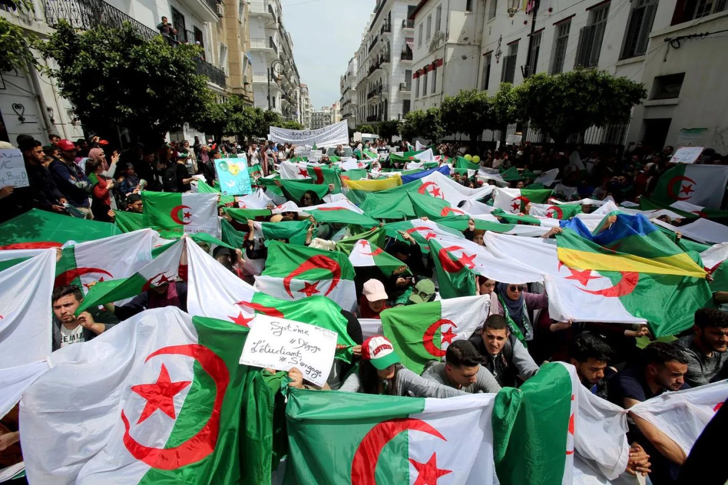 Demonstrators hold flags and banners during anti government protests in Algiers, Algeria April 23, 2019. (Reuters)