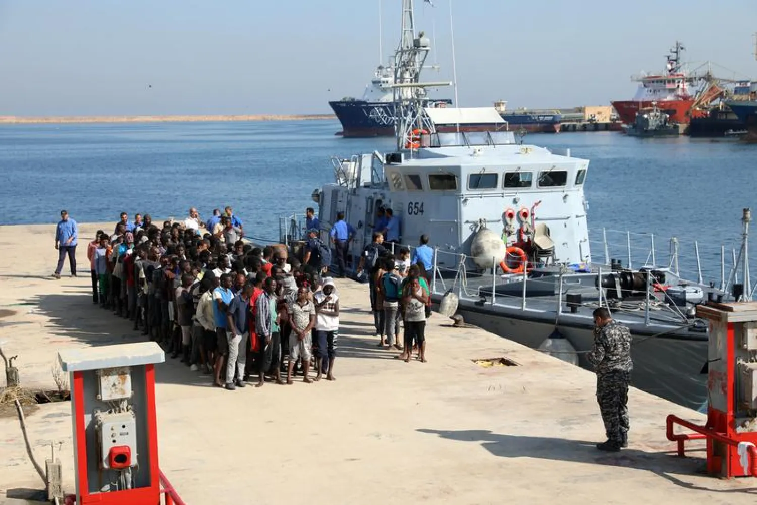 Migrants line up upon their arrival at a naval base after they were rescued by Libyan coastguard, in Tripoli, Libya August 29, 2017. REUTERS/Hani Amara
