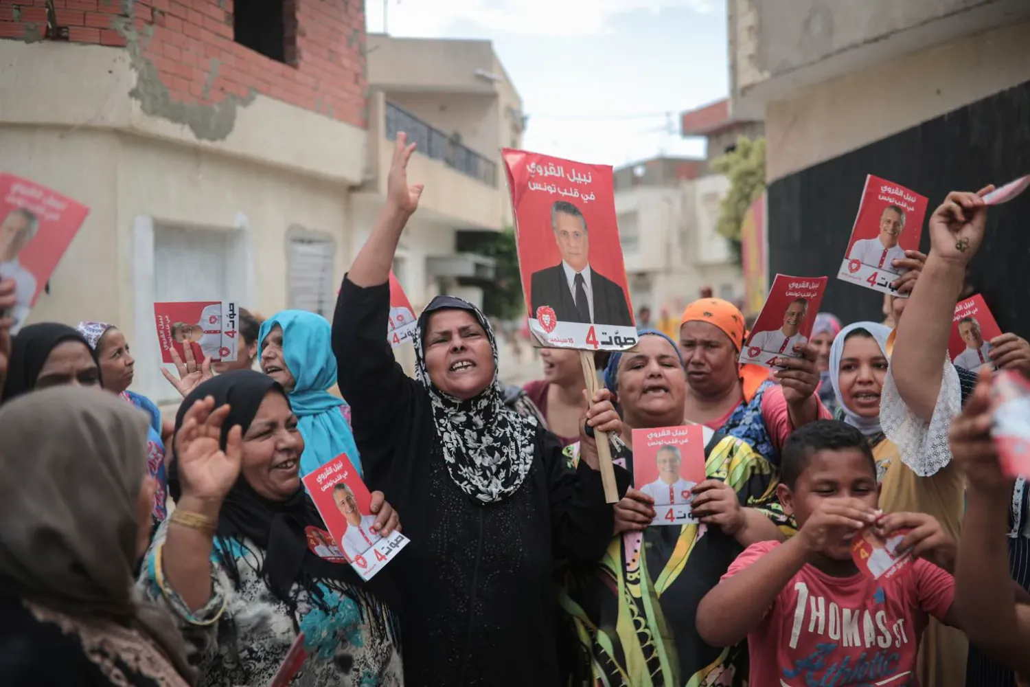 In this Saturday, Sept. 21, 2019 photo, supporters of jailed media magnate Nabil Karoui chant for his freedom and carry posters which were provided to them by his campaign officials, in Nabeul, west of Tunis, Tunisia. 
 (Mosa’ab Elshamy/Associated Press)
