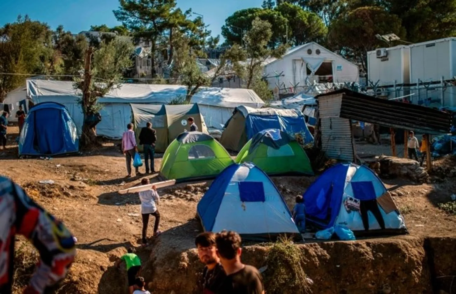 Refugees and migrants gather at Moria camp on the island of Lesbos, on September 30, 2019, follwing a fire at the refugee camp which houses some 13,000 people. ( AFP / ANGELOS TZORTZINIS)