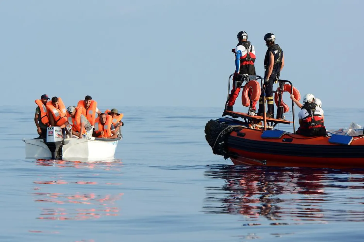 Migrants are seen on board a fiberglass boat in the Mediterranean Sea, off the Libyan Coast, August 12, 2018. REUTERS/Guglielmo Mangiapane