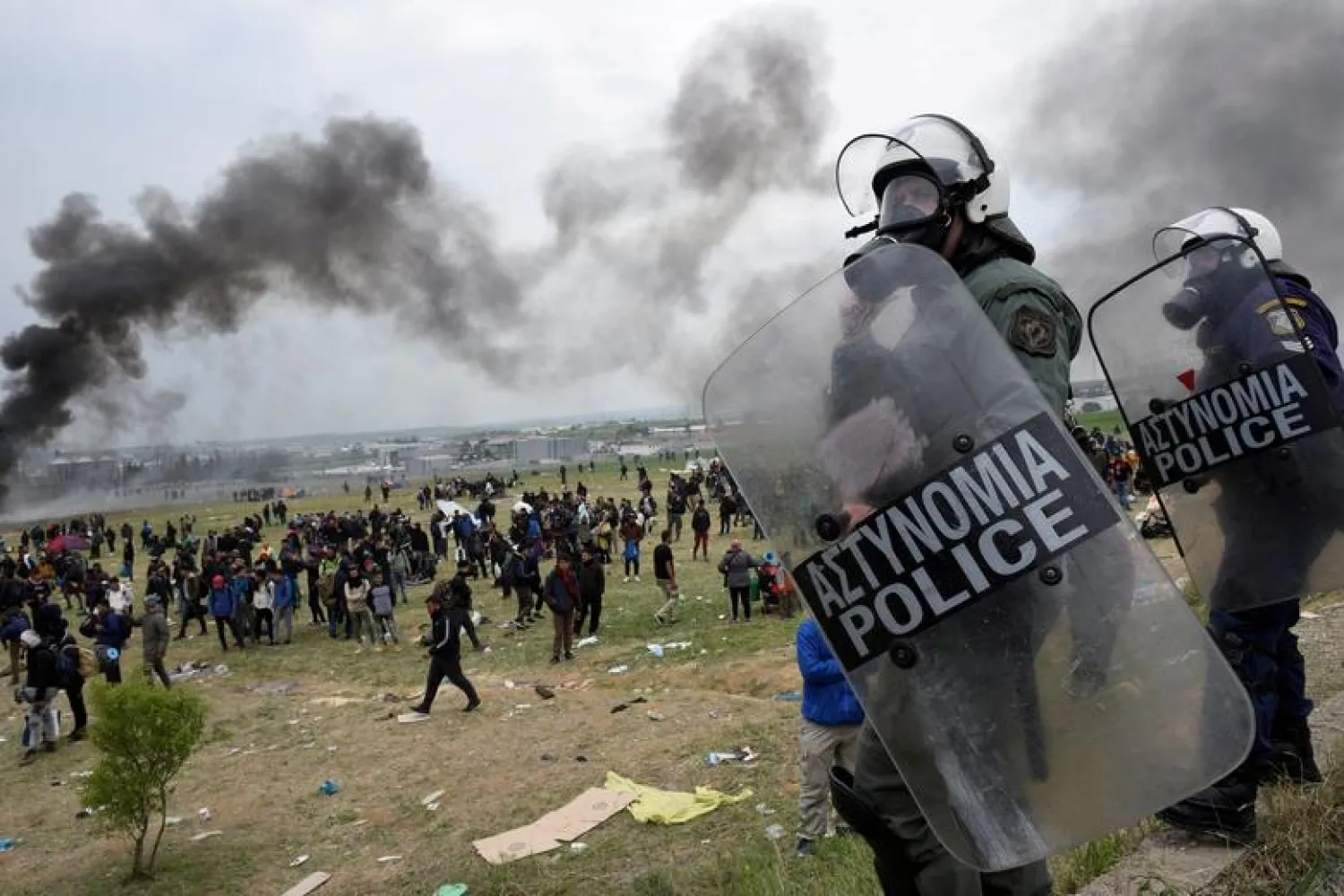 Riot police officers stand during clashes outside a camp in the town of Diavata in northern Greece, April 6. REUTERS/Alexandros Avramidis

