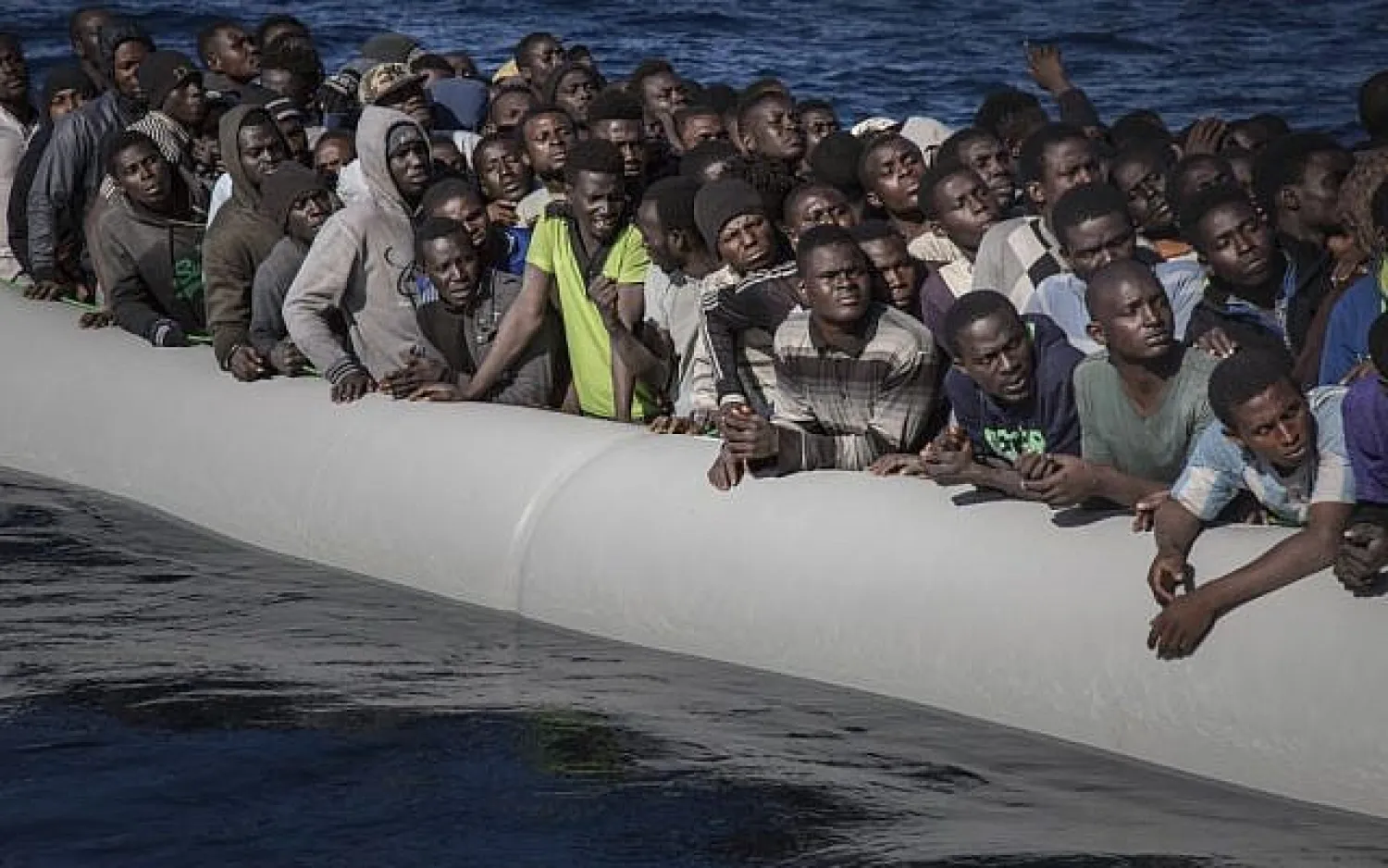 African migrants wait to board the MV Aquarius, as 193 people and two corpses are recovered Friday, January 13, 2017, from international waters in the Mediterranean Sea about 22 miles (35 Km) north of Sabrata, Libya. (AP Photo/Sima Diab)
