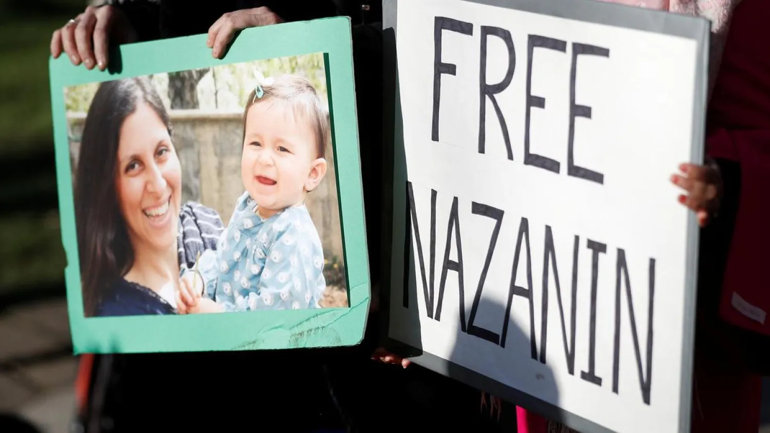 Demonstrators hold placards in support of Nazanin Zaghari-Ratcliffe. (Reuters)