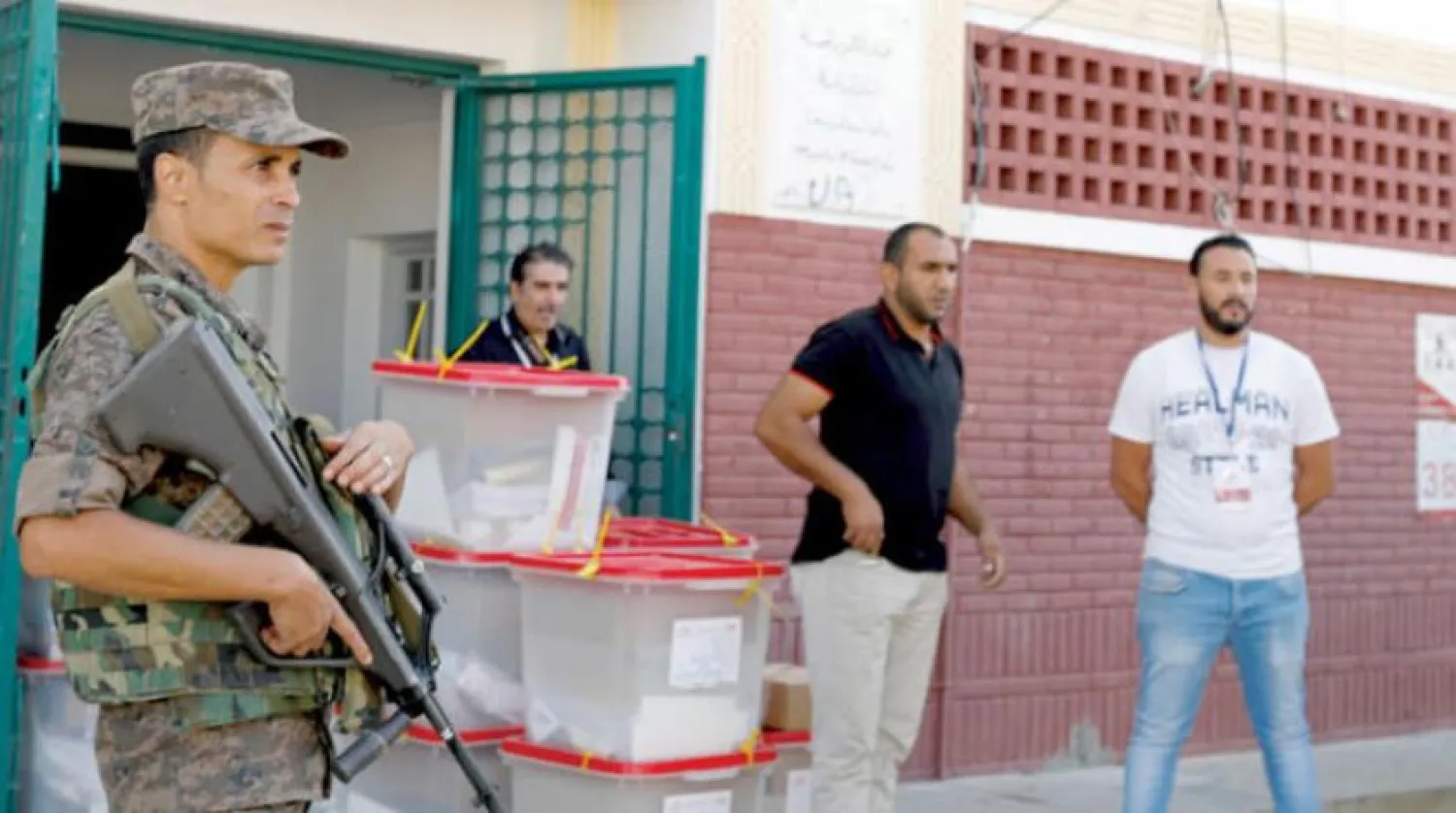 Policeman secures ballot boxes for parliamentary elections in Tunisia on Sunday, October 6, 2019. (Reuters)