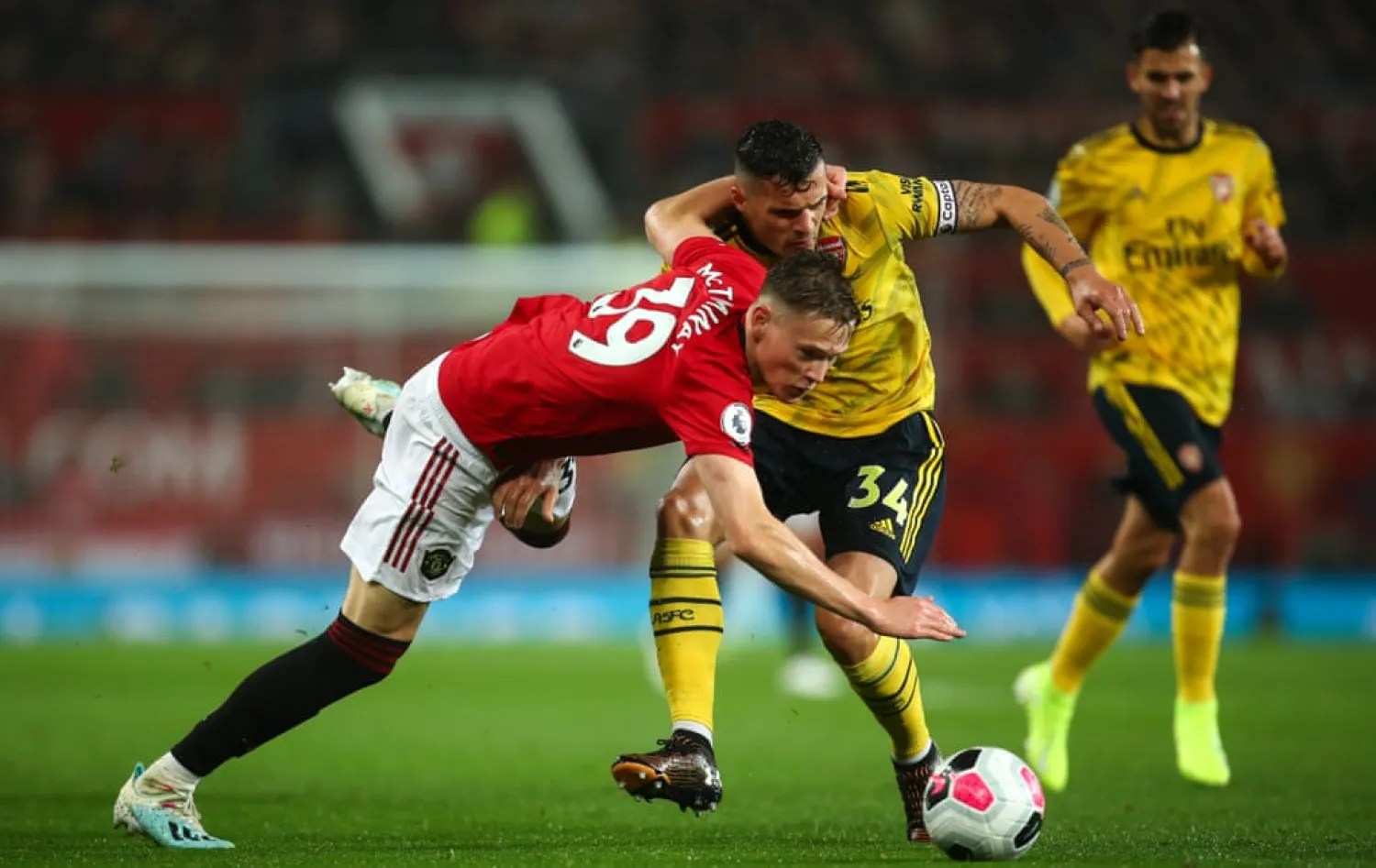  Scott McTominay of Manchester United and Arsenal’s Granit Xhaka tussle for the ball at Old Trafford on Monday night. Photograph: Robbie Jay Barratt - AMA/Getty Images
