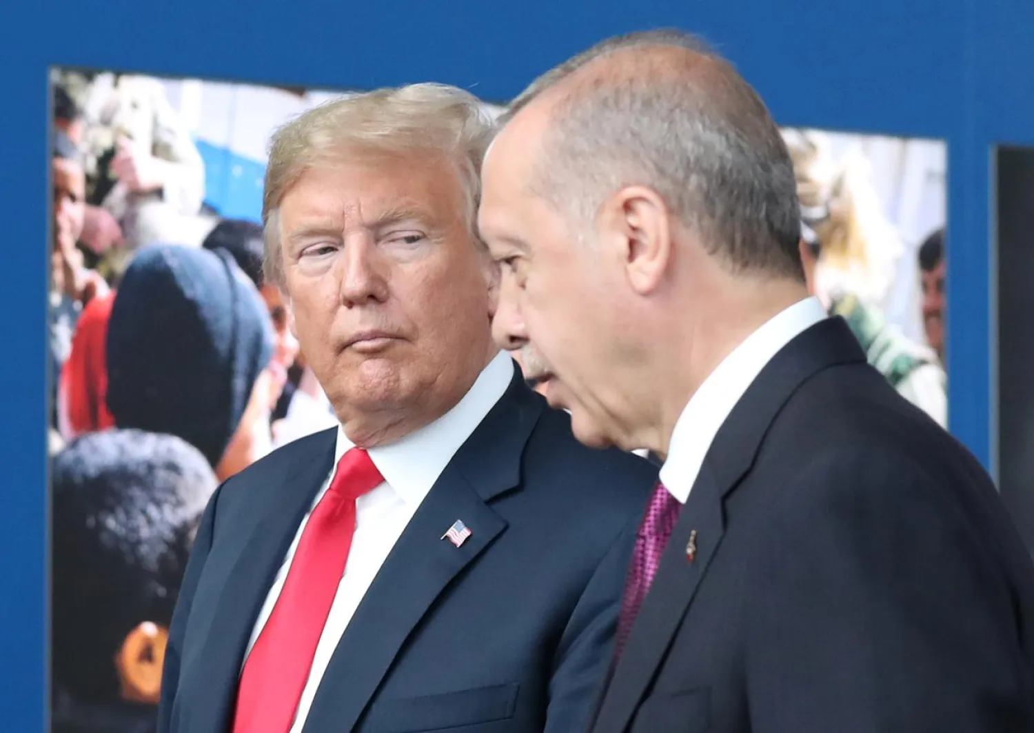 US President Donald Trump (L) talks to Turkey’s President Recep Tayyip Erdogan (R) at NATO headquarters in Brussels, Belgium, 11 July 2018. (Reuters)