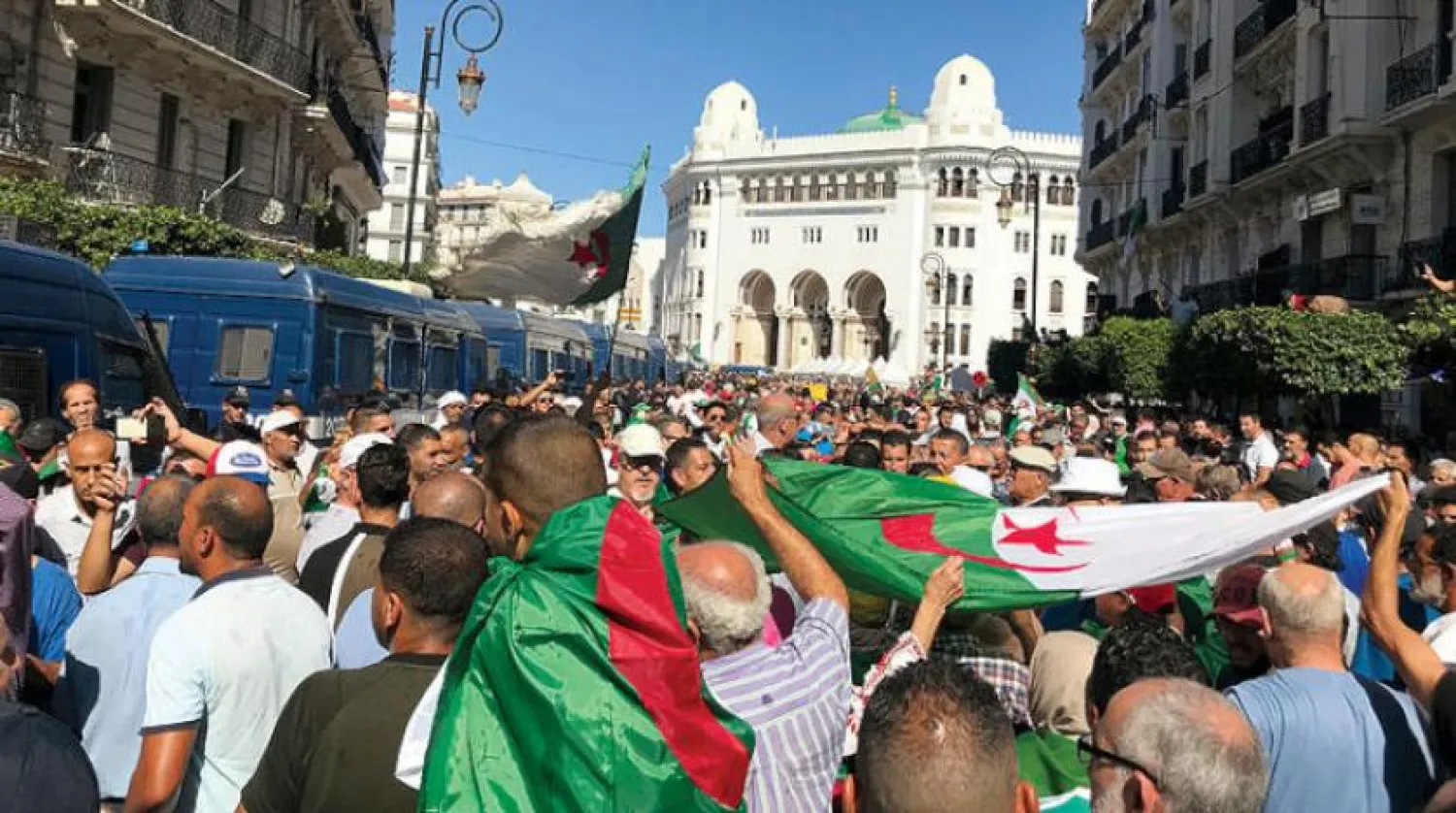 Protesters raise Algerian flags in Algiers on Friday, October 4, 2019 (Reuters)