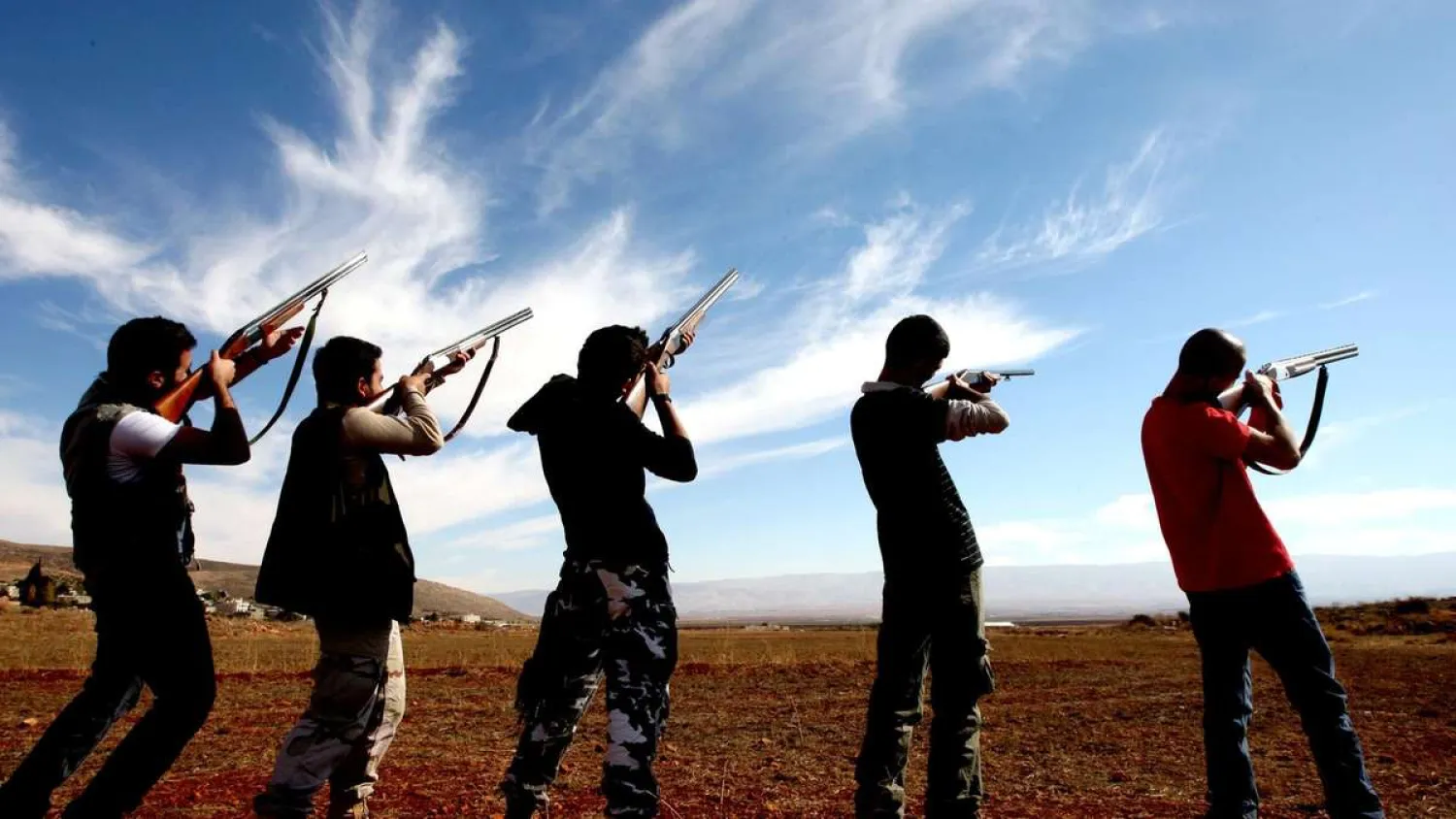 Hunters aim at a flock of birds in the Lebanese village of Shlifa. (AFP)