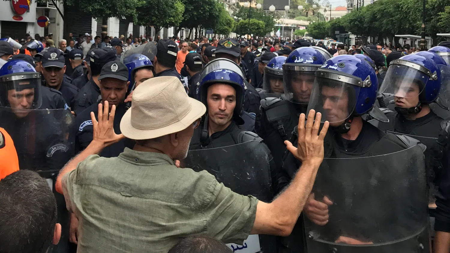 A demonstrator gestures towards police officers during a protest demanding the removal of the ruling elite in Algiers, Algeria September 13, 2019. REUTERS/Abdelaziz Boumzar