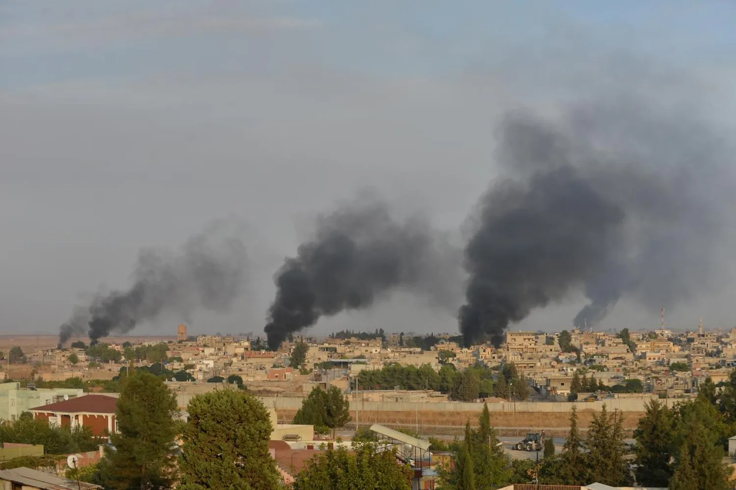 Smoke rises from the Syrian border town of Ras al-Ain as it is pictured from the Turkish town of Ceylanpinar in Sanliurfa province, Turkey, October 9, 2019. REUTERS/Stringer