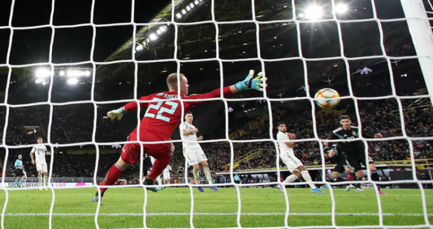 لوكاس أوكامبوس (يمين) يهدي التعادل المثير لمنتخب الأرجنتين (إ.ب.أ)