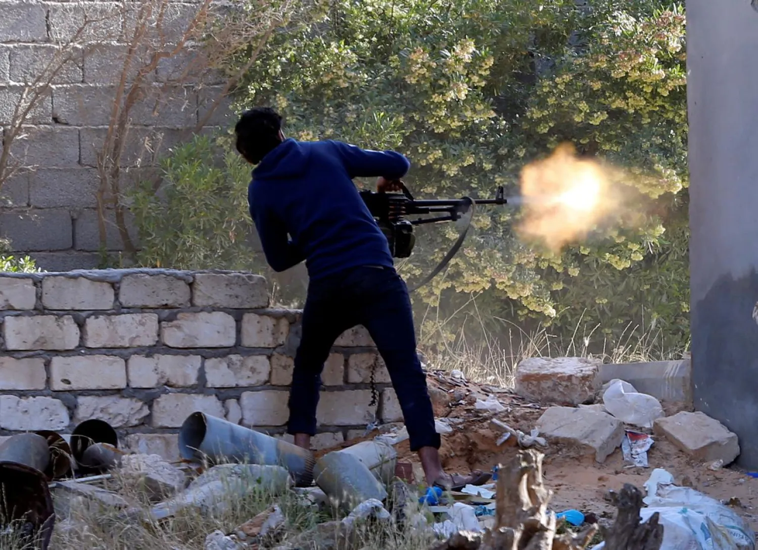 A GNA member fires during a fight with the LNA in Ain Zara, Tripoli, Libya April 28, 2019. REUTERS/Ismail Zitouny