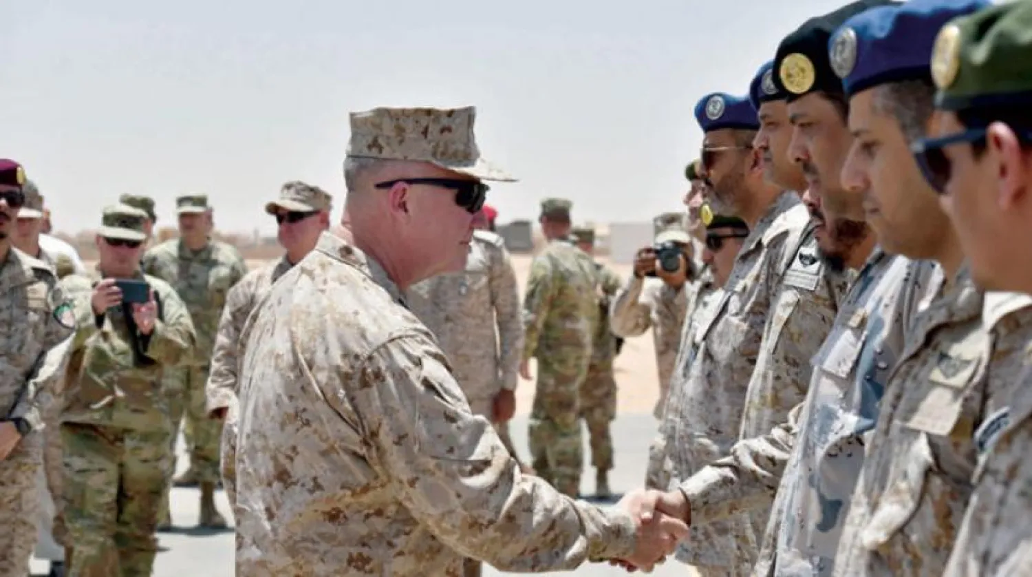 In this file photo taken on July 18, 2019, US Marine Corps General Kenneth F. McKenzie Jr. (C-L), Commander of the US Central Command (CENTCOM), shakes hands with Saudi military officers during his visit to a military base in al-Kharj in central Saudi Arabia. AFP 