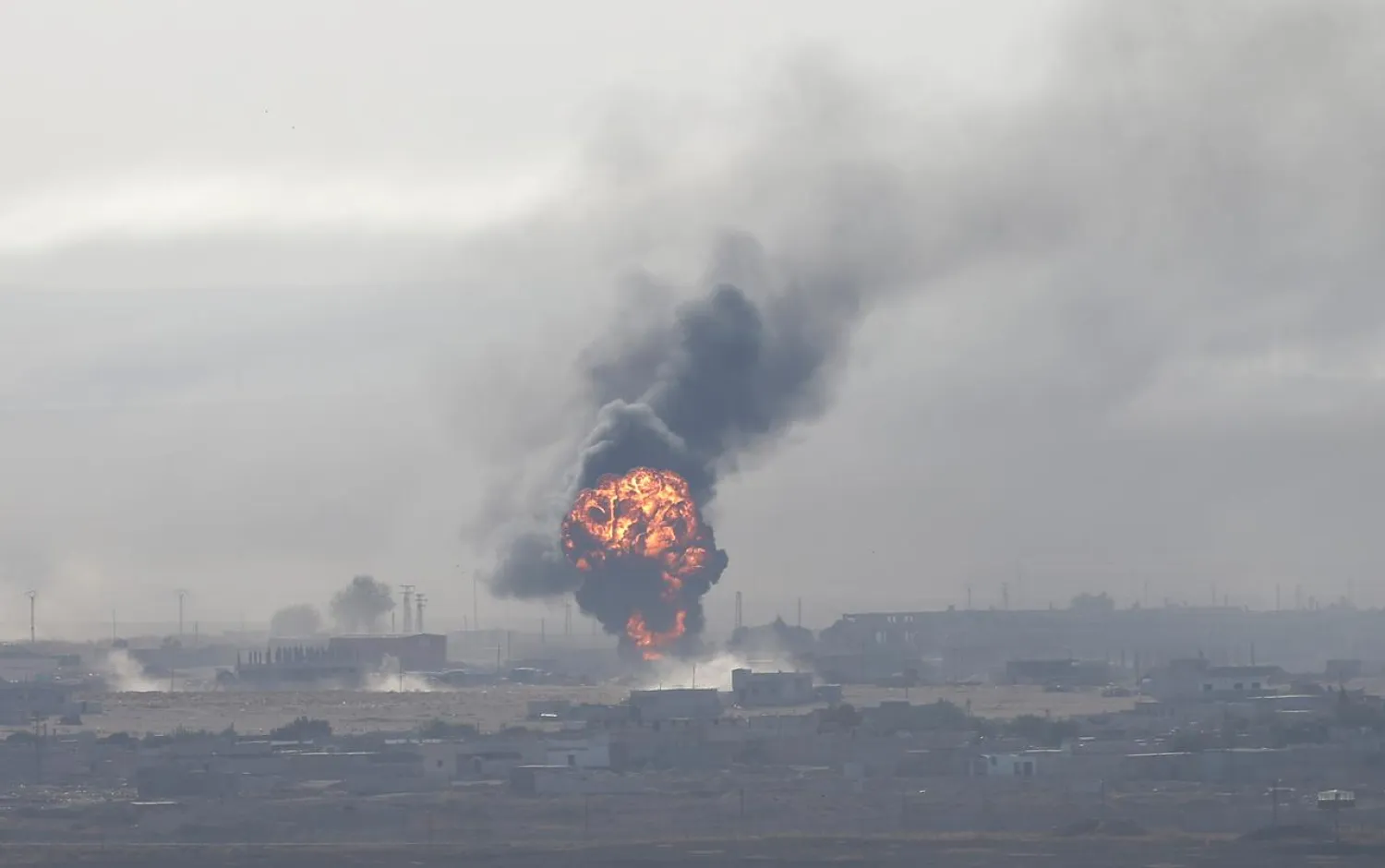 An explosion over the Syrian town of Ras al-Ain as seen from the Turkish border town of Ceylanpinar, Sanliurfa province, Turkey, October 12, 2019. REUTERS/Stoyan Nenov