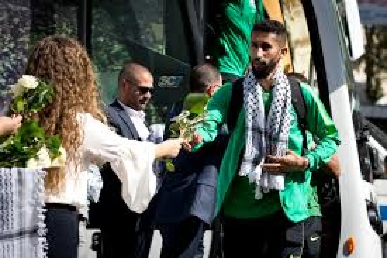 Palestinians welcome the Saudi Arabia national team in West the West Bank city of Ramallah, Sunday, Oct. 13, 2019. Saudi Arabia's national soccer team has arrived in the West Bank for its first match in the Palestinian territories, a qualifying match for the 2020 World Cup. (AP Photo/Majdi Mohammed)