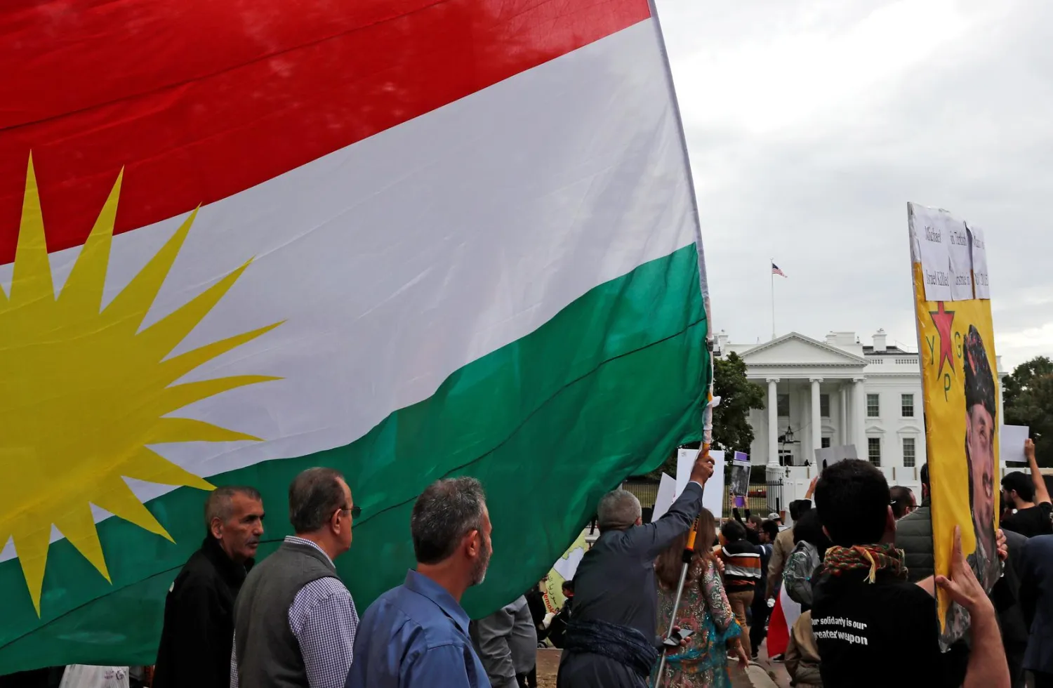 Members of the American Rojava Center for Democracy, an organization that advocates for freedom, democracy, and peace in Syria, take part with other activists in a rally to protest Turkey's incursion into Kurdish-controlled northeast Syria and urge U.S. action against Turkey, outside the White House in Washington, U.S, October 12, 2019. REUTERS/Carlos Jasso
