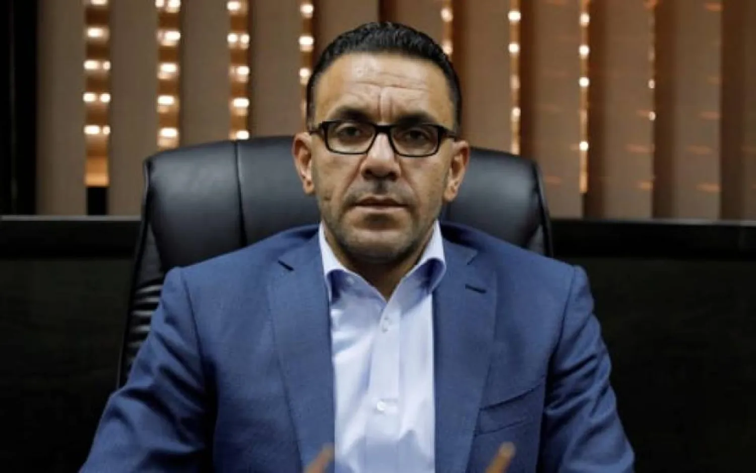 The Palestinian Authority's governor of Jerusalem, Adnan Ghaith, seated at his ministry in the occupied West Bank town of Al-Ram, near the disputed city | AFP