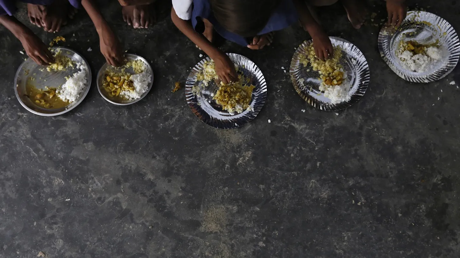 Schoolchildren eat their free mid-day meal, distributed by a government-run primary school at Brahimpur village in Chapra district of the eastern Indian state of Bihar July 19, 2013. (Reuters)