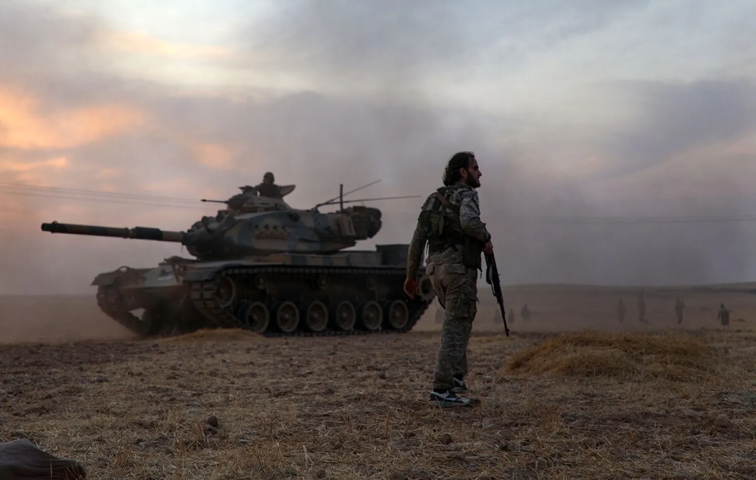 Turkey-backed Syrian fighters gather around a Turkish tank in the northern outskirts of the Syrian city of Manbij near the Turkish border on Oct. 14, 2019. (Getty Images)