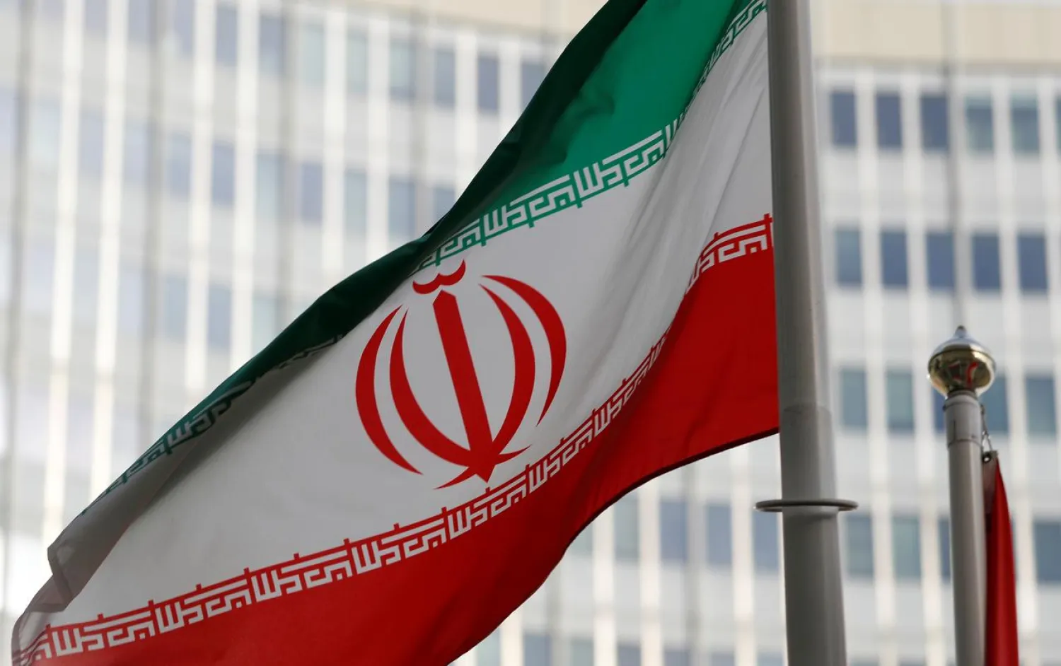 FILE PHOTO: The Iranian flag flutters in front the International Atomic Energy Agency (IAEA) headquarters in Vienna, Austria March 4, 2019. REUTERS/Leonhard Foeger/File Photo