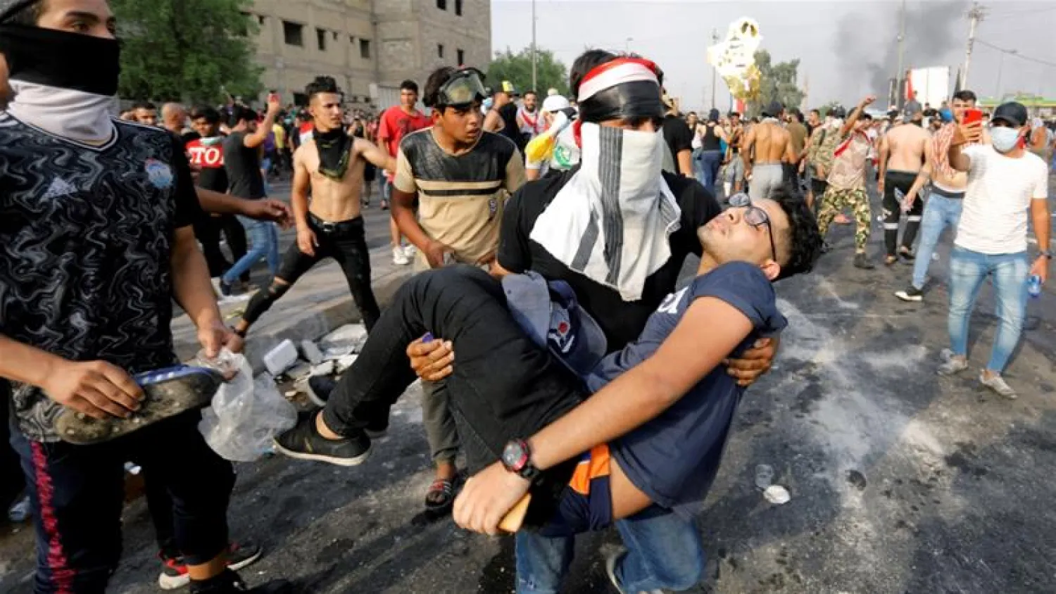 A man carries away a demonstrator who was injured during a protest in Baghdad, Iraq. Khalid al-Mousily/Reuters