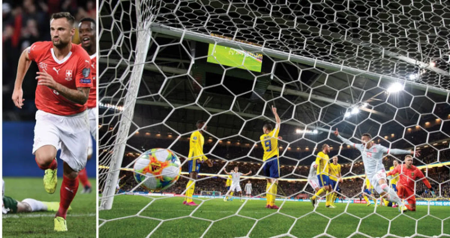 رودريغو مورينو (يمين) يحتفل بهدفه في مرمى السويد الذي ضمن لإسبانيا التأهل (إ.ب.أ)  -  السويسري سيفيروفيتش يحتفل بهدفه في مرمى آيرلندا 
(أ.ف.ب)