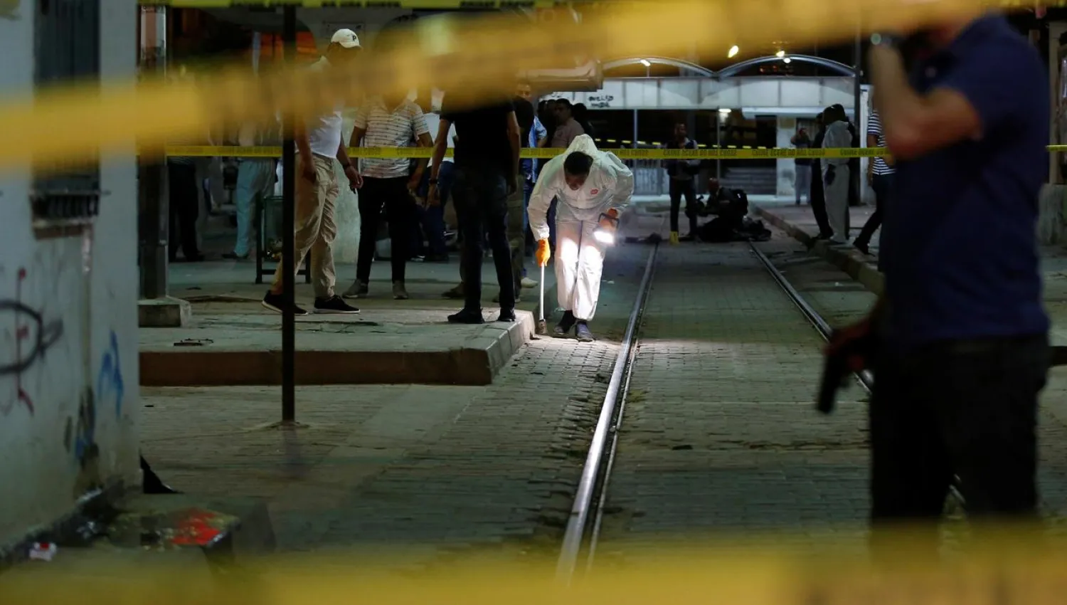 Authorities inspect the scene after a man reported to be wearing an explosive belt died in the Intilaka area in Tunis, Tunisia July 3, 2019. Reuters