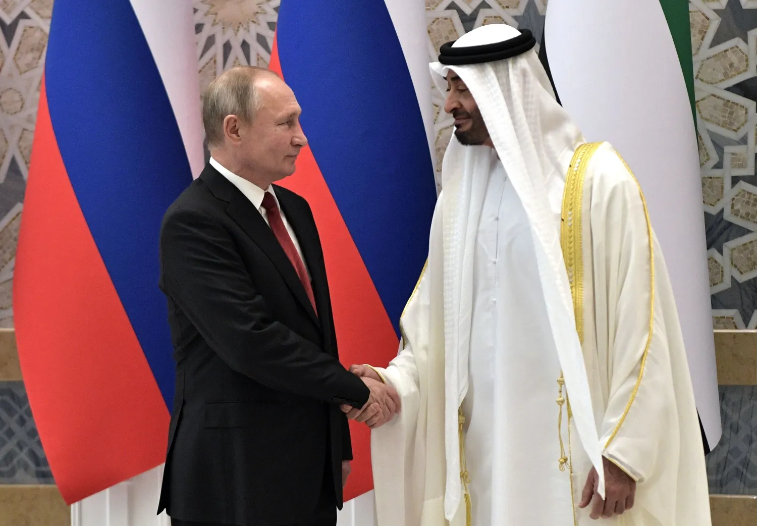 Russian President Vladimir Putin, left, and Abu Dhabi Crown Prince Mohamed bin Zayed al-Nahyan pose for a photo during the official welcome ceremony in Abu Dhabi, United Arab Emirates, Tuesday, Oct. 15, 2019. (Alexei Nikolsky, Sputnik, Kremlin Pool Photo via AP)