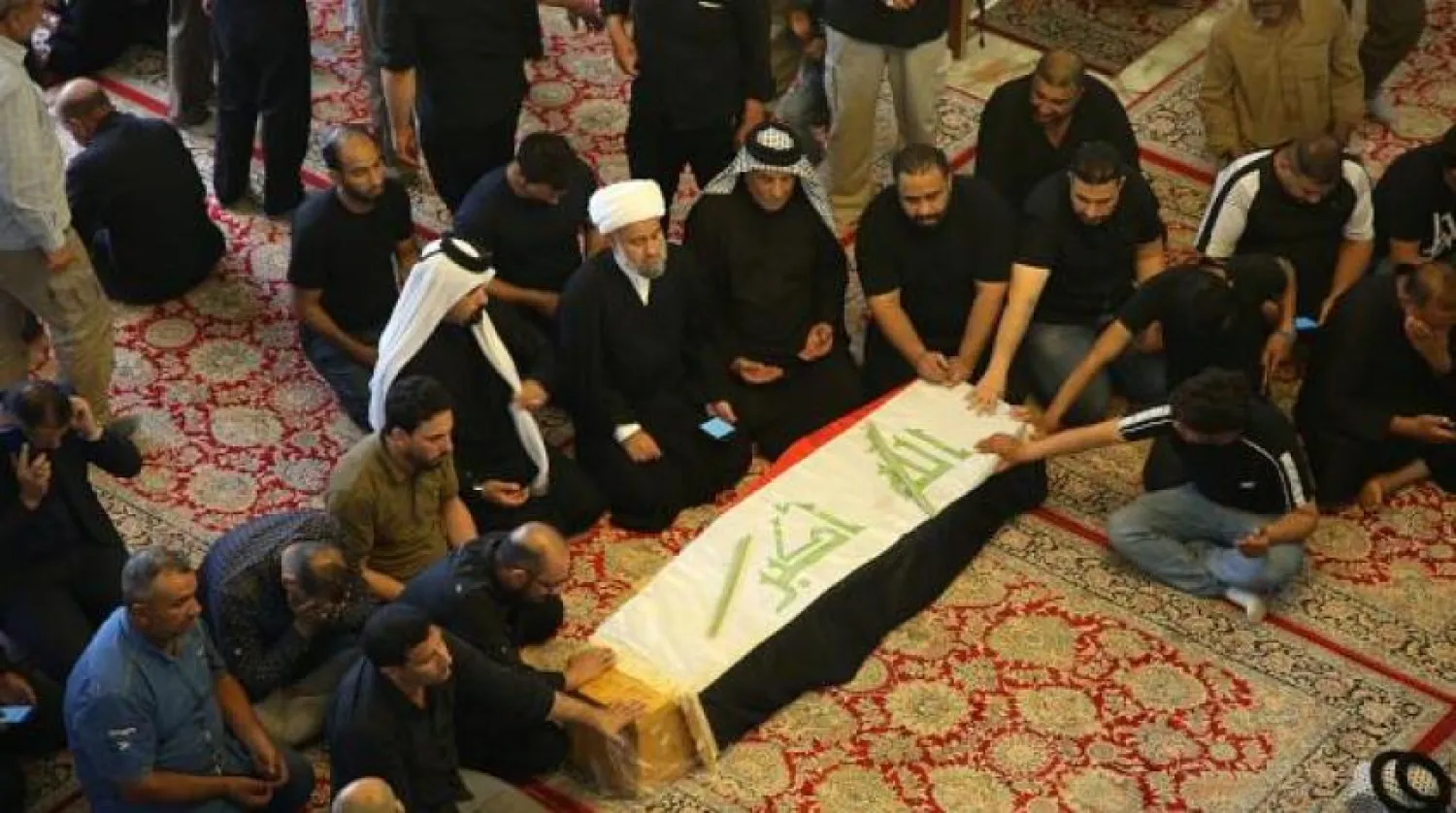 Mourners pray during the funeral of a protester killed in Iraq's Najaf. AP photo