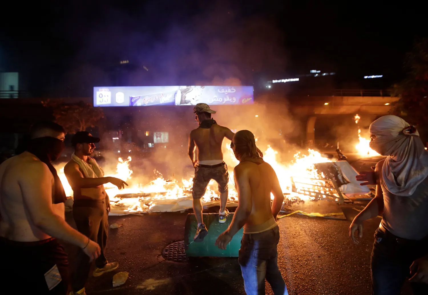  Demonstrators burn wood and debris during a protest on Oct. 17. Photographer: Anwar Amro/AFP