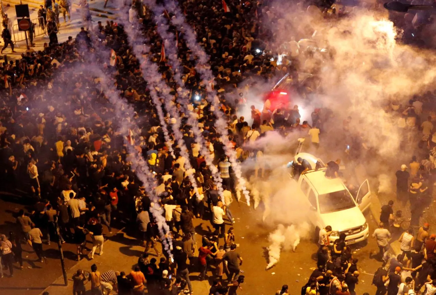 Riot police fire tear gas to disperse demonstrators during a protest targeting the government over an economic crisis, near the government palace in Beirut, Lebanon October 18, 2019. REUTERS/Mohamed Azakir