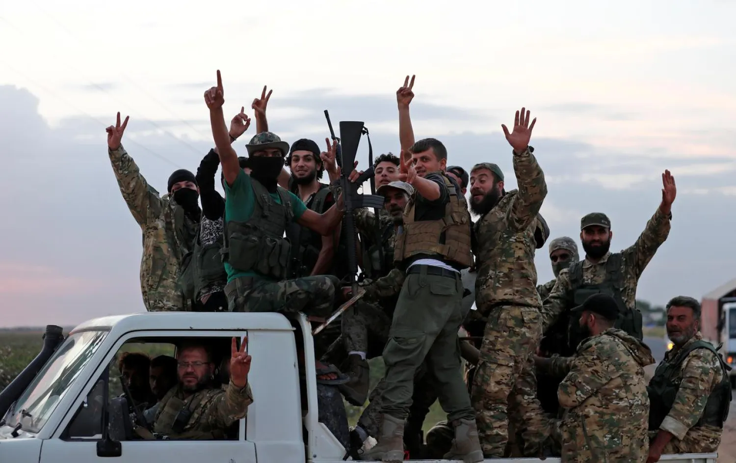 Turkey-backed Syrian fighters drive on top of a truck to cross into Syria, near the border town of Akcakale in Sanliurfa province, Turkey, October 17, 2019. REUTERS/Murad Sezer