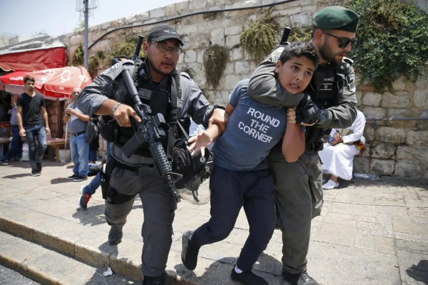 Israeli border guards detain a Palestinian boy during a demonstration outside Al-Aqsa mosque compound (AFP)
