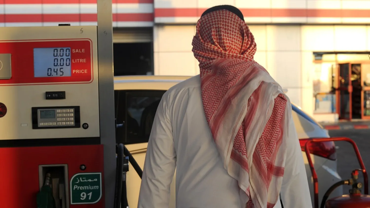 A Saudi man walks past a pump at a petrol station in the Red Sea city of Jeddah. (Getty Images)