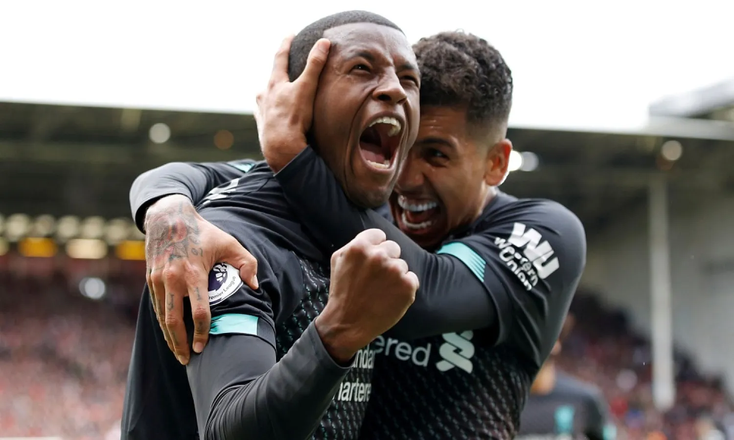 Georginio Wijnaldum, left, and Roberto Firmino celebrate after the Dutchman scored Liverpool’s winning goal at Sheffield United. (Reuters)