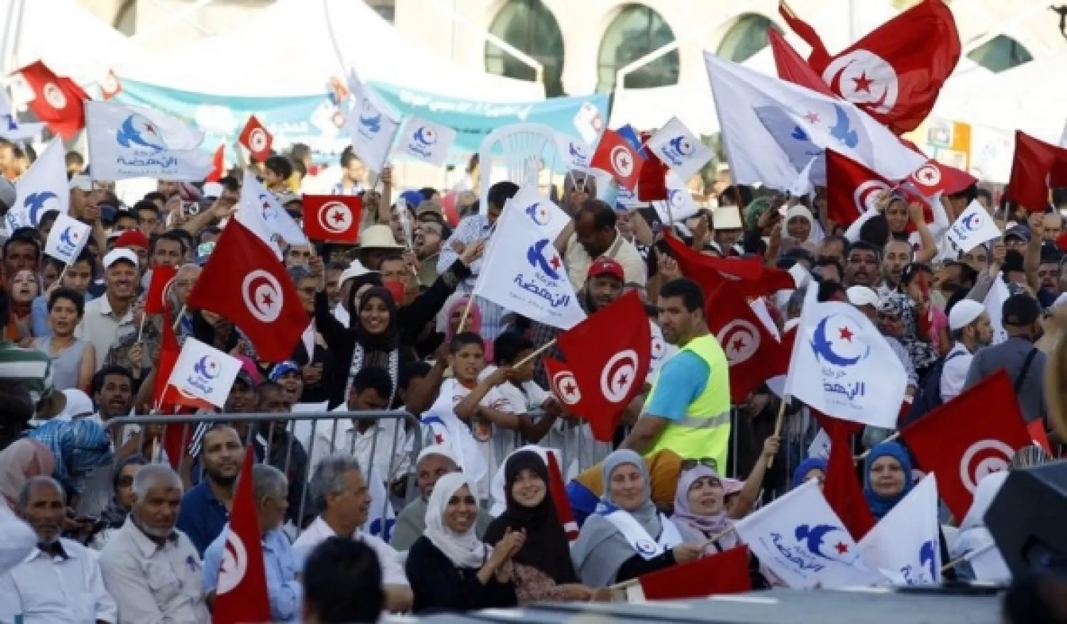 Supporters of Ennahda movement wave national and party flags as they mark the 33rd anniversary of the founding of the party in Tunis June 7, 2014. REUTERS/Zoubeir Souissi 